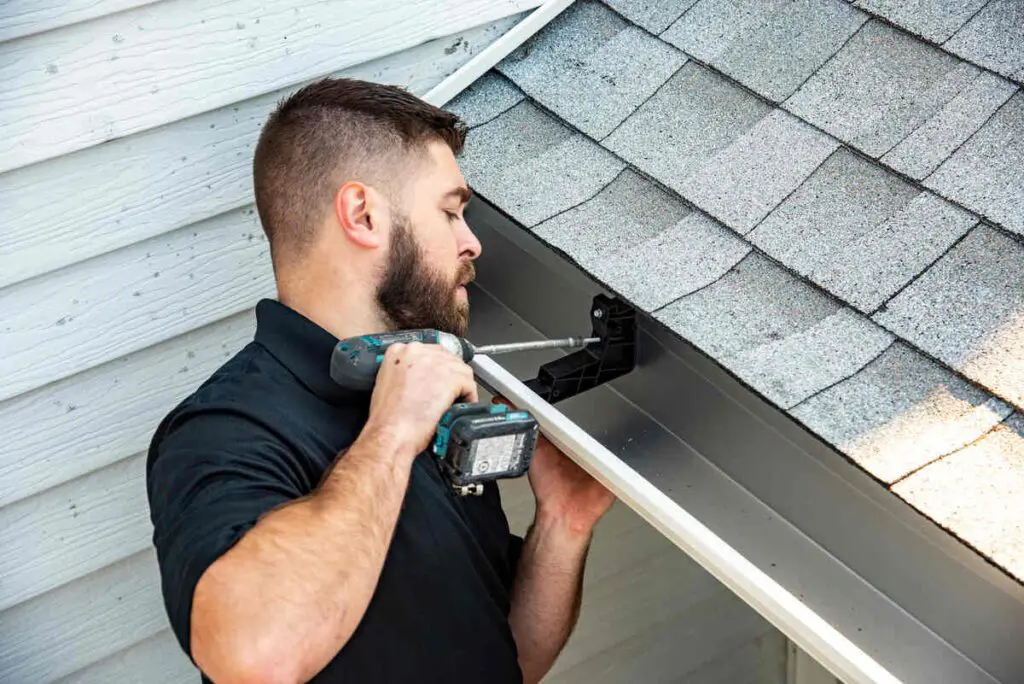 American Eagle employee performing gutter replacement