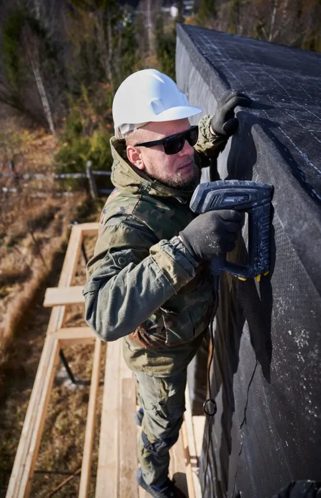 man installing roof on minnesota home