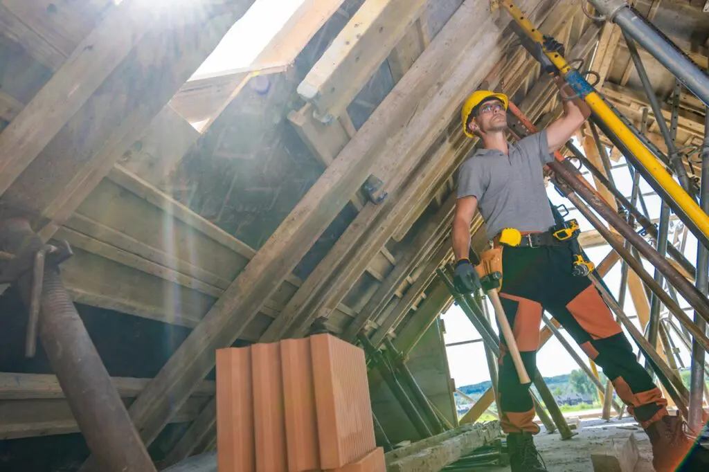 Construction Worker Lifting Materials During a Sunny Day at a Building Site