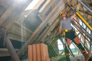 Construction Worker Lifting Materials During a Sunny Day at a Building Site
