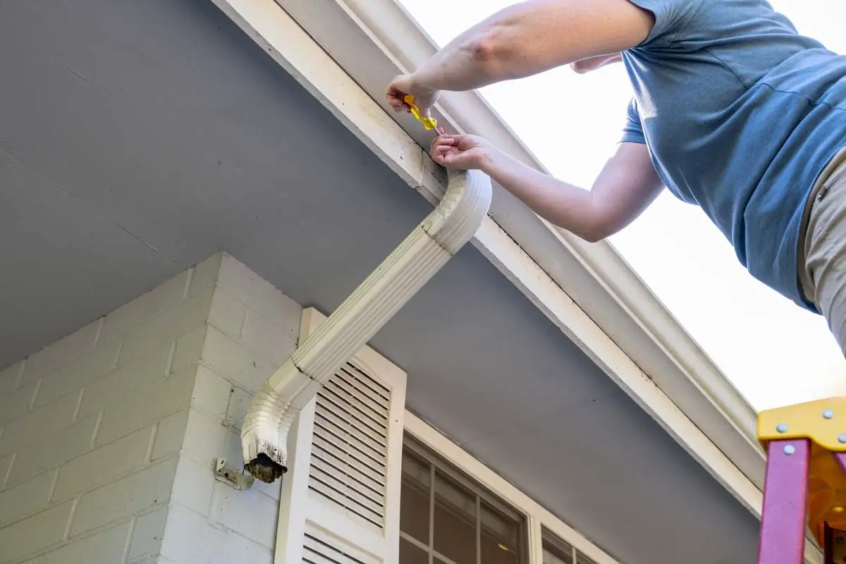 close shot of man repairing gutter in Minnesota